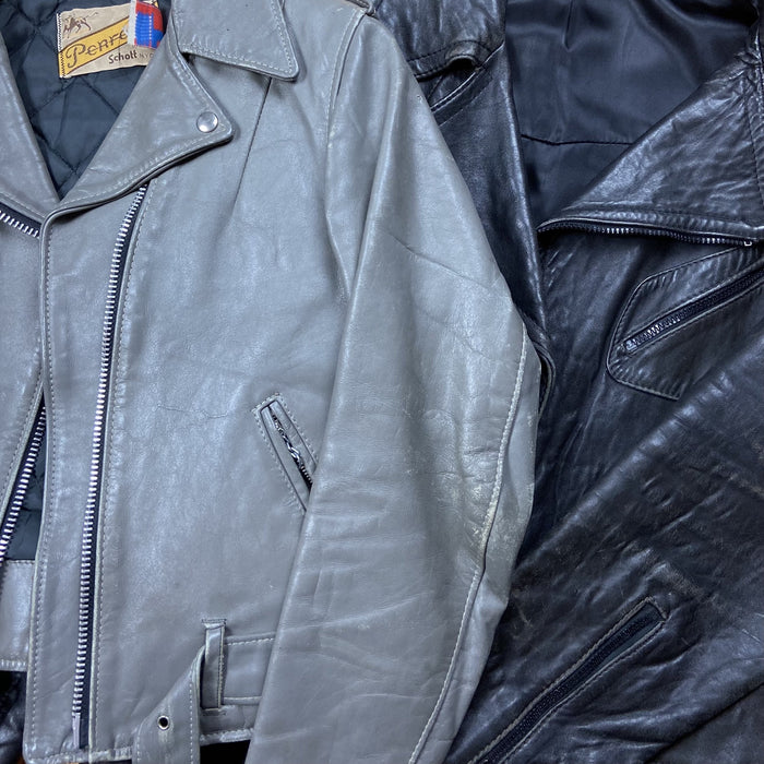 Zu sehen sind zwei Echtleder Jacken in Grau und Schwarz.