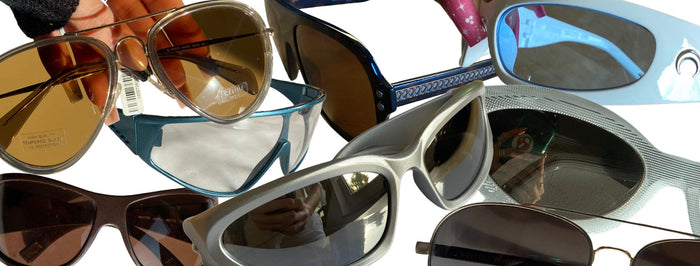 Zu sehen sind acht unserer Designer Sonnenbrillen vor einem weißen Hintergrund.