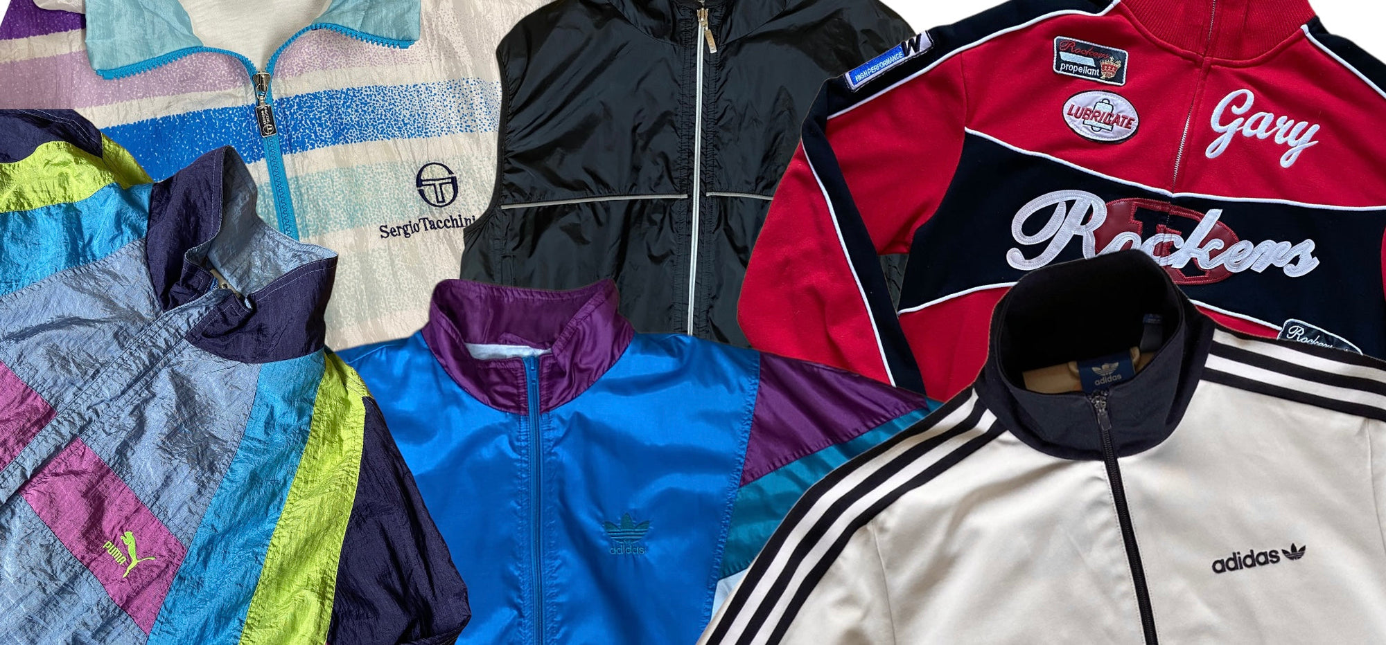 Zu sehen ist eine Auswahl an 90/80s Track Jackets, wie zum Beispiel eine Silberne von Adidas oder eine Multicolored von Puma.