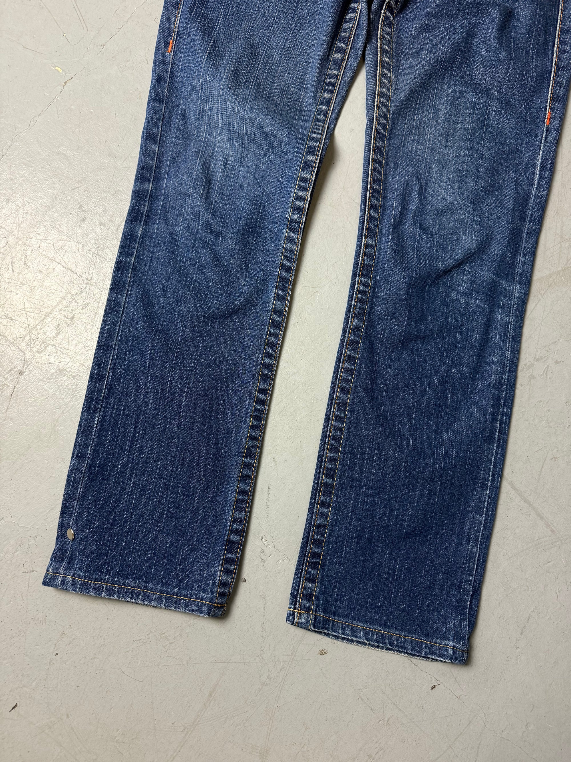 Eine dunkelblaue Straight leg True religion Jeans mit orangen Nähten 