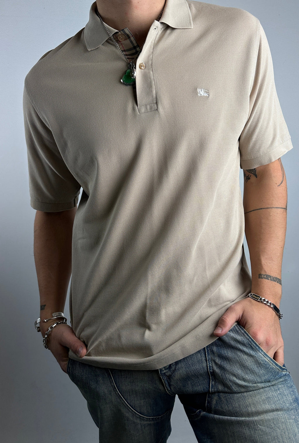 Tragebild von beigenem Burberry Polo vor grauer Wand 