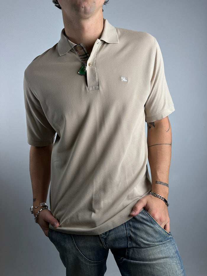 Tragebild von beigenem Burberry Polo vor grauer Wand 