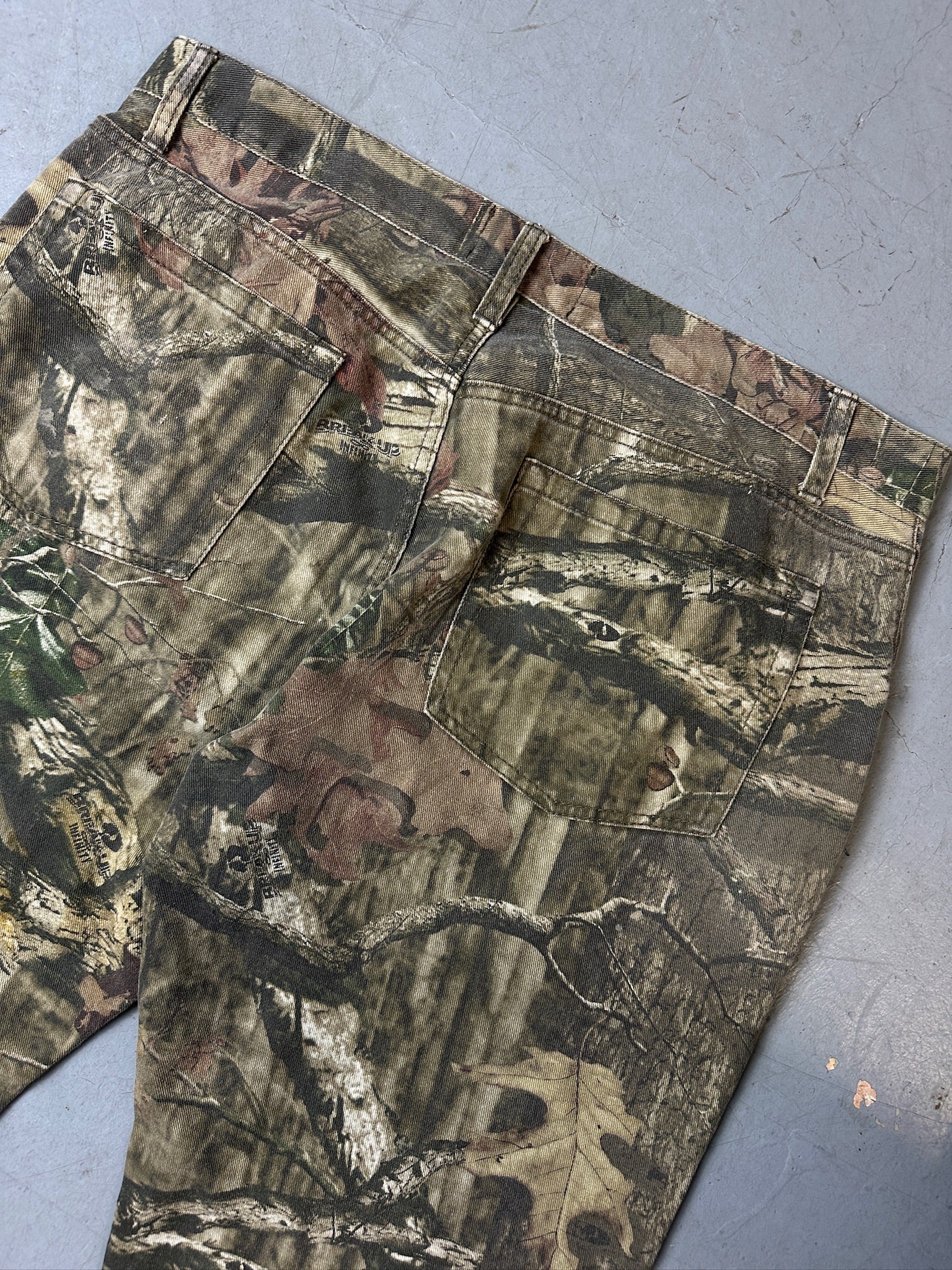 Eine baggy Hose von mossy oak in real tree camouflage Optik 
