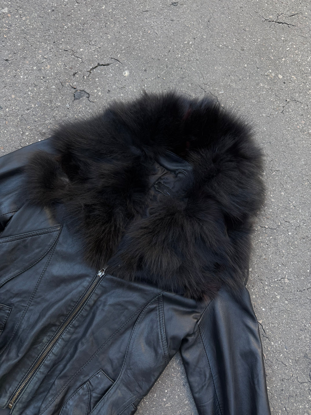 Eine schwarze Lederjacke mit Faux Fur am Kragen und an den Ärmeln