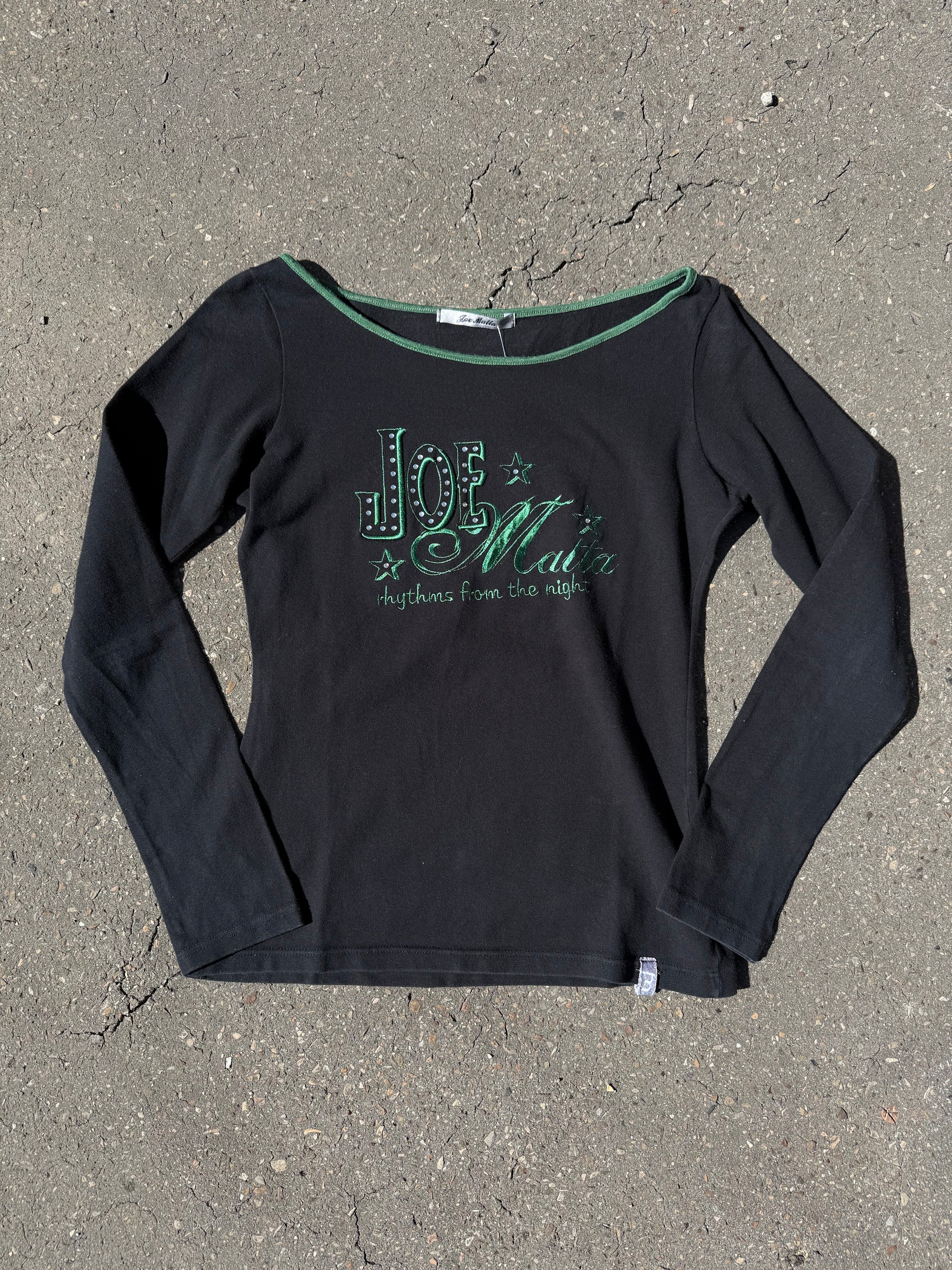 Ein schwarzes longsleeve mit einem grünen Joe Matta Aufschrift auf der Brust