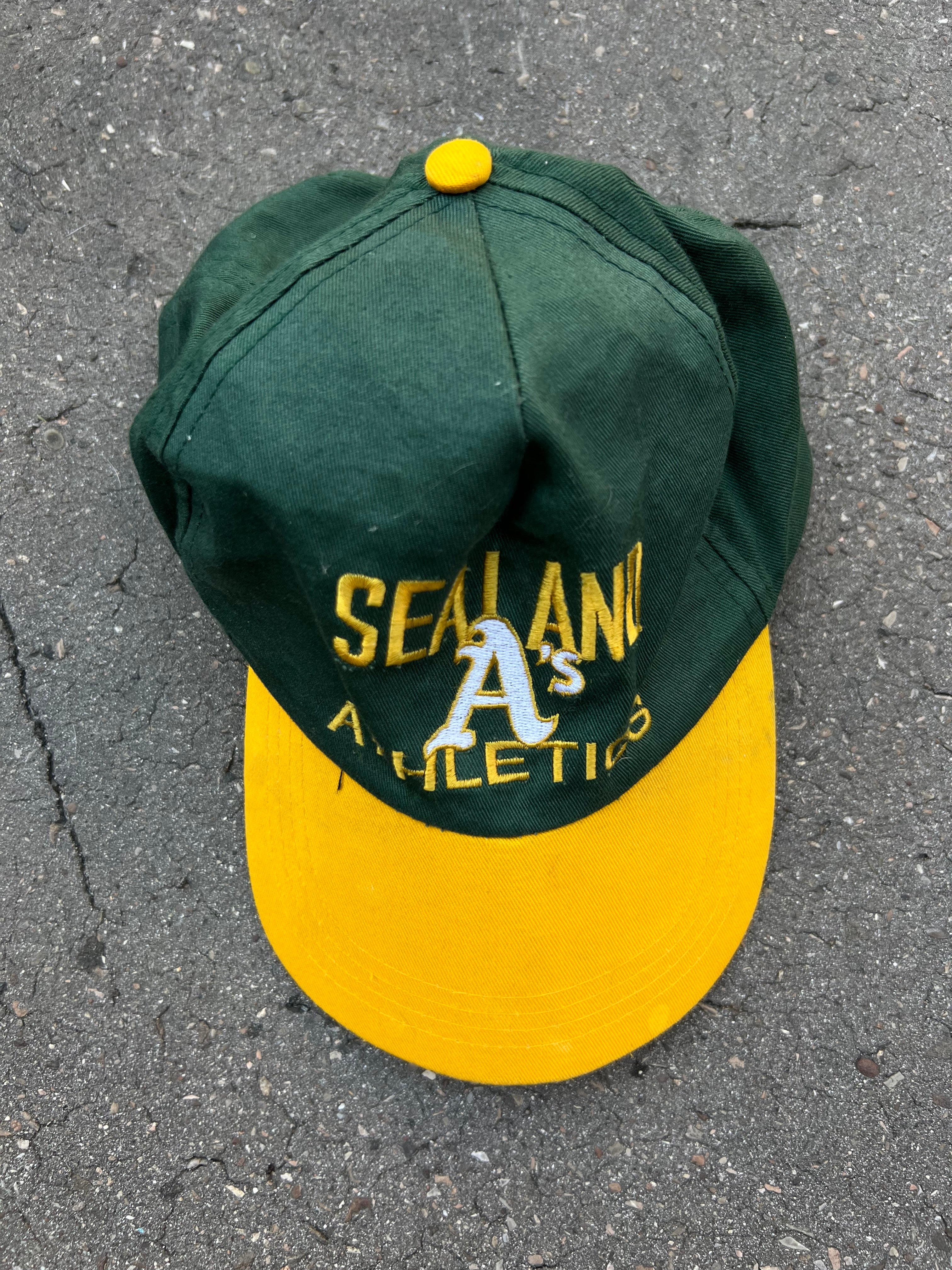 Eine grüne Cap mit gelben Sealand Schriftzug und gelben Schirm