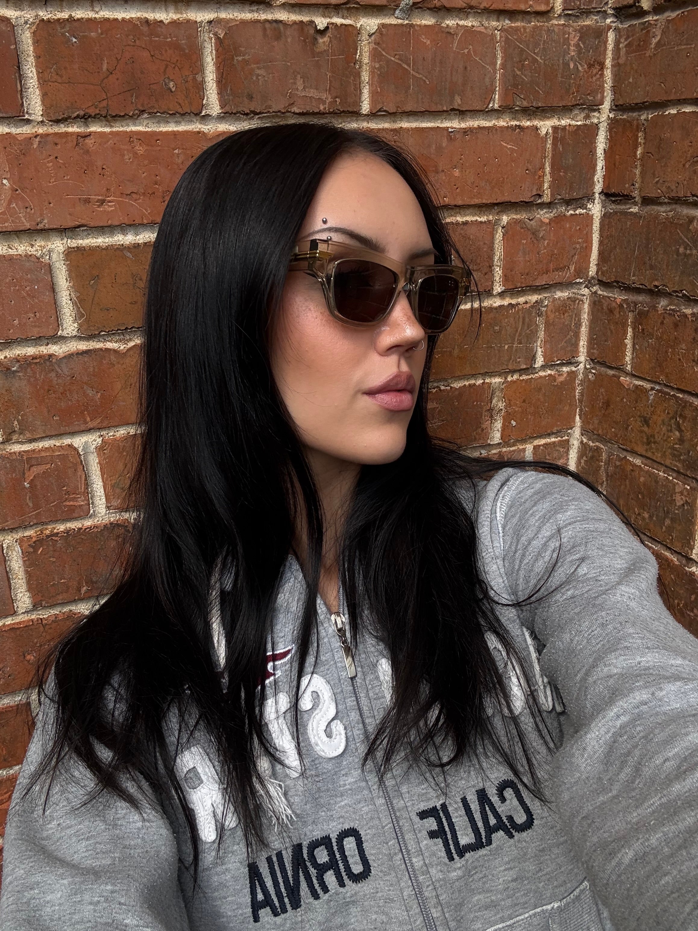 Eine beige transparente Sonnenbrille von Bottega Veneta mit Gold Details