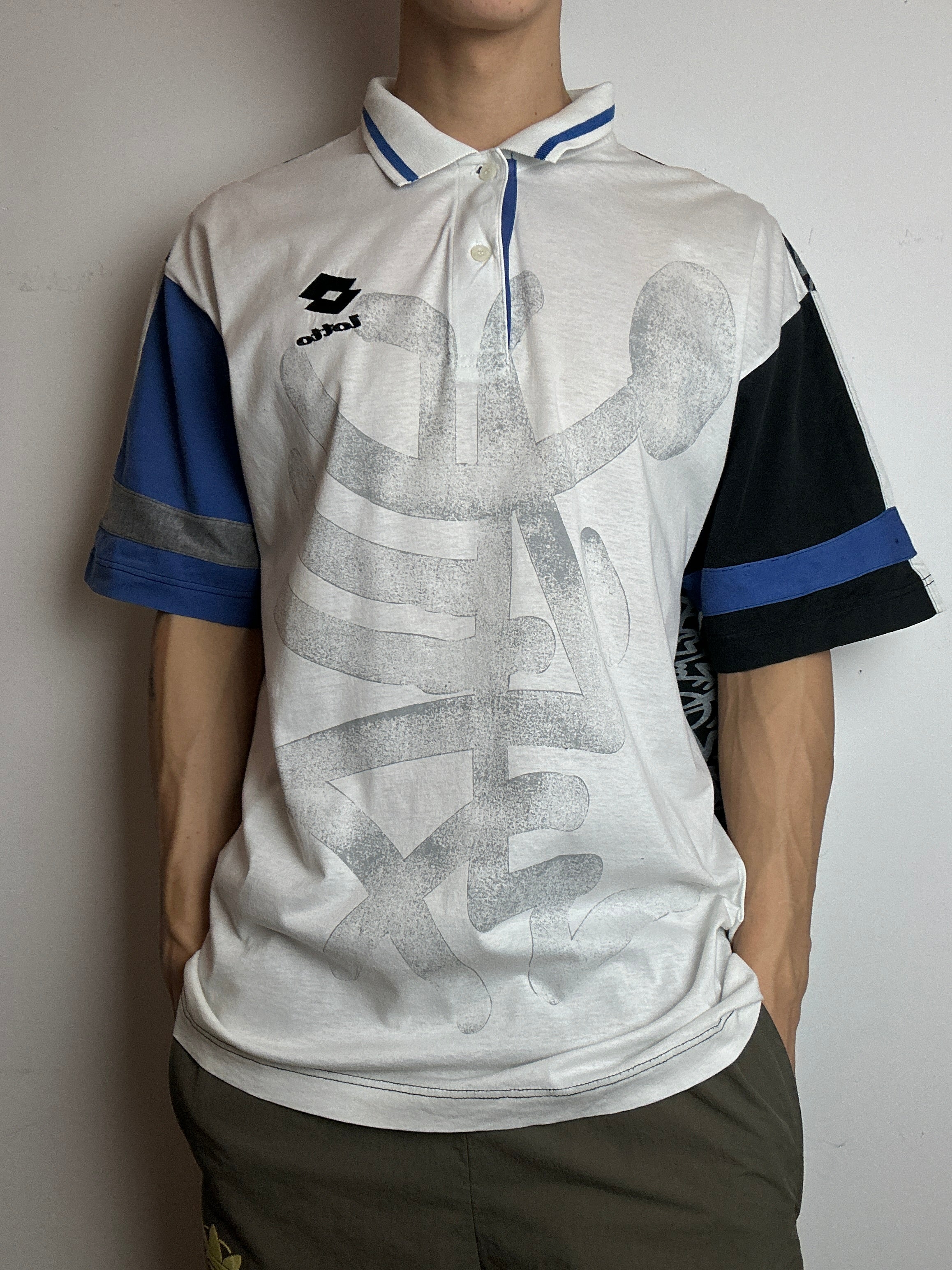 Ein Polo Shirt von Lotto in weiß mit blau schwarzen Ärmeln vintage Y2K 