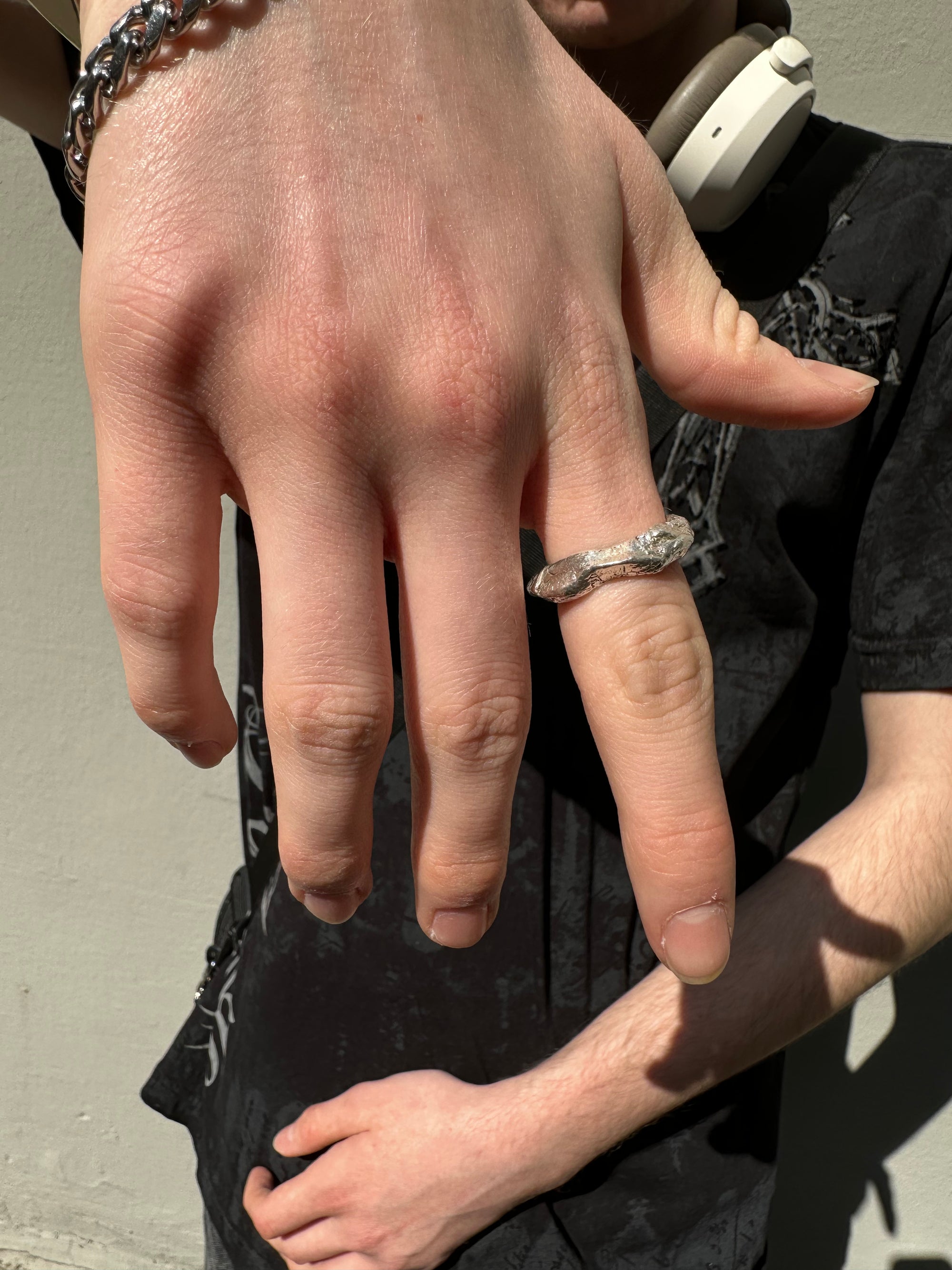 Ringsbyclausen Ring „Handgeformt“ Tragebild vom Zeigefinger vor Wand